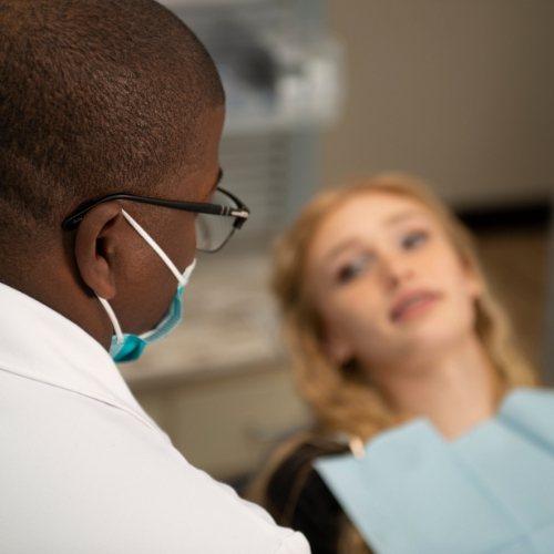 Dentist talking to patient about replacing missing teeth in Arlington Heights