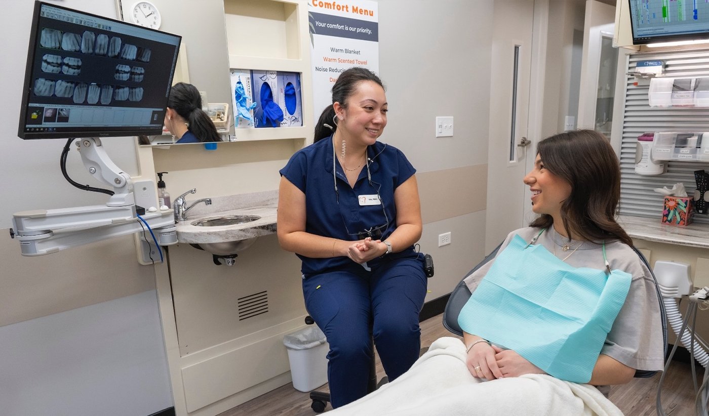Dentist talking to a patient after an oral cancer screening in Arlington Heights