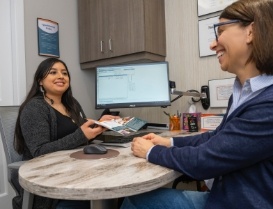 Dental team member handing a pamphlet to a patient