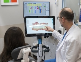 Dentist showing a patient a screen with digital models of their teeth