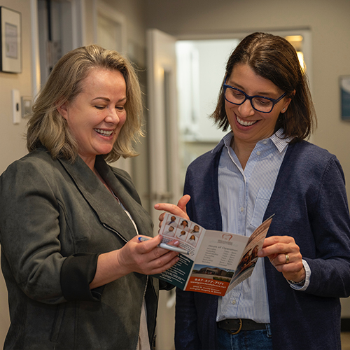 Dental team member showing a pamphlet to a patient