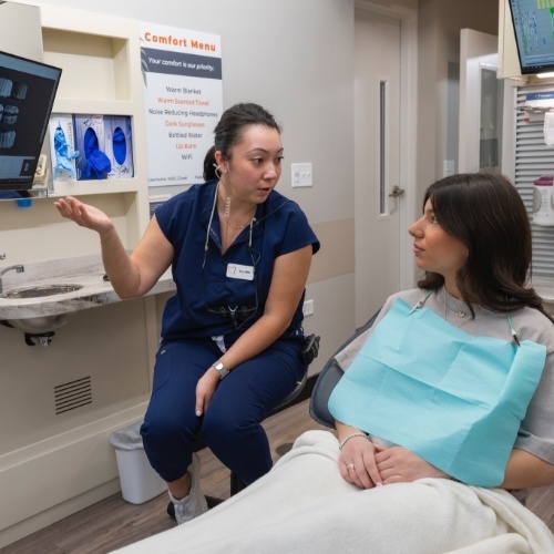 Dental team member explaining something to a patient