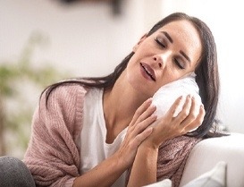 Woman holding an ice pack to her face