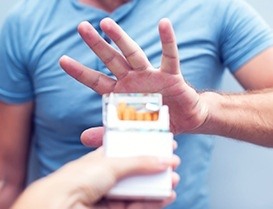 Man saying no to offered cigarettes