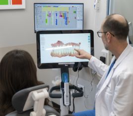 Dentist showing a patient digital scans of their teeth