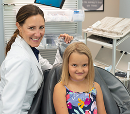 Young blonde girl smiling at dental appointment