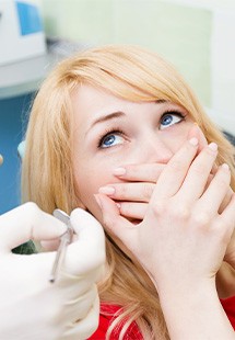 Woman afraid in the dental chair