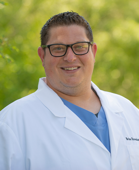 Doctor Rosenblatt smiling in white lab coat