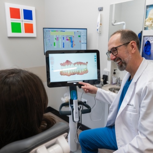 Dentist showing a patient digital impressions of their teeth