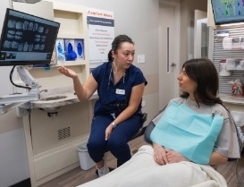 Dental team member showing a patient x rays of their teeth