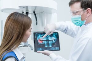 Dentist and patient talking about dental X-ray