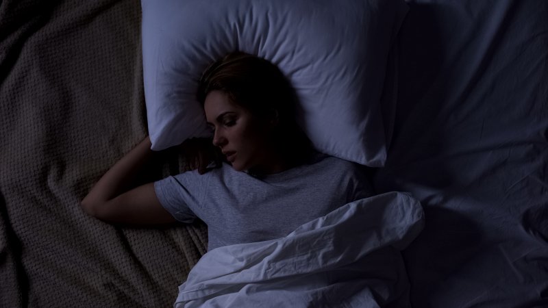 woman in bed with sleep apnea