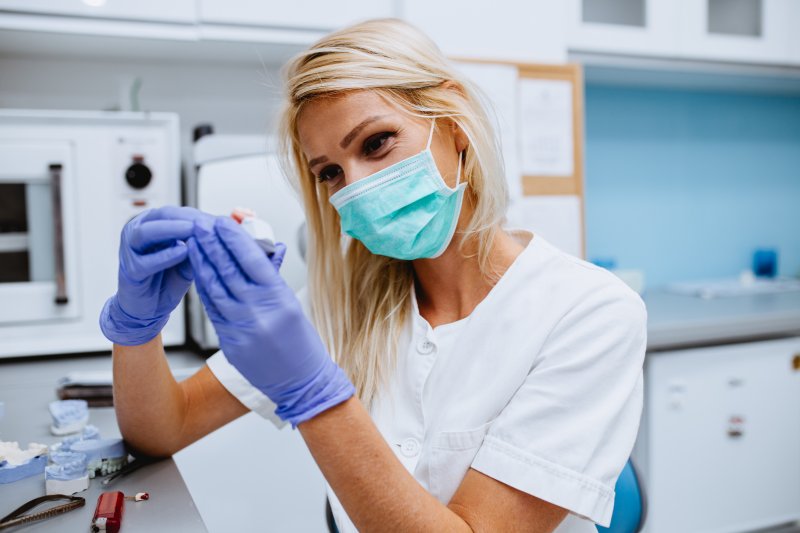 Dentist working on replacement dental crowns